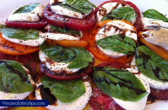 A salad of Heirloom Tomatoes with mozzarella and a balsamic vinegar glaze.