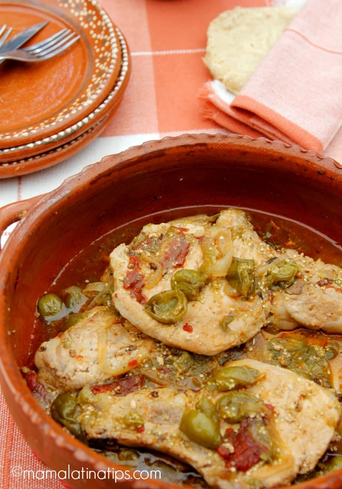 Pork chops with tomatillos and chipotles in a clay cazuela