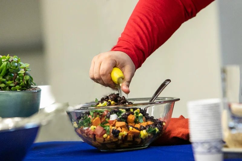 Squeezing lime juice on a Mexican sweet potato salad