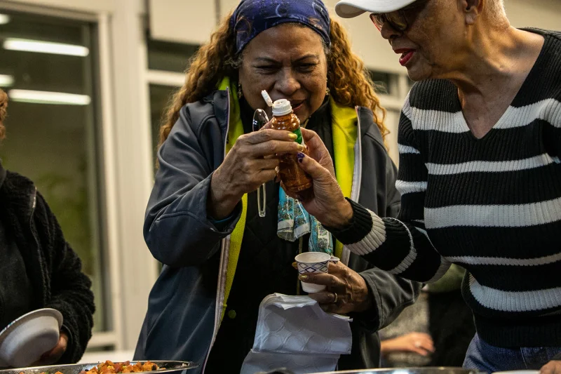 Ladies looking at a Tajin bottle